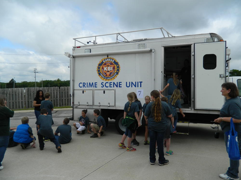 Kids looking at a crime scene unit